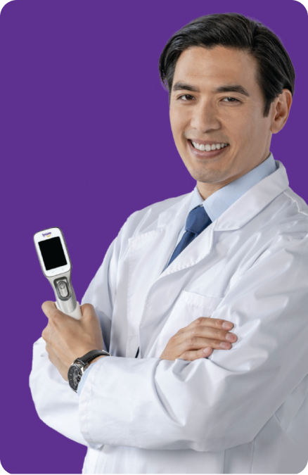 Smiling eye doctor holding Systane® iLux ²® device